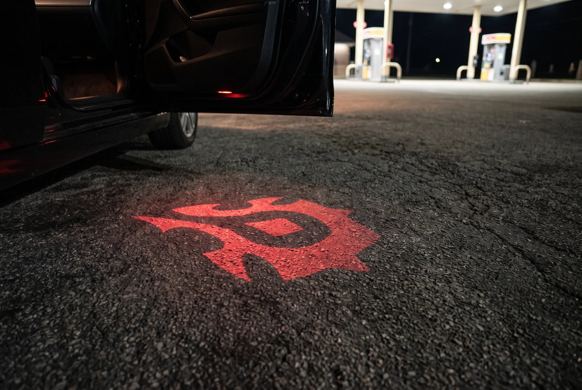 Crimson Horde projection beside a car at a gas station